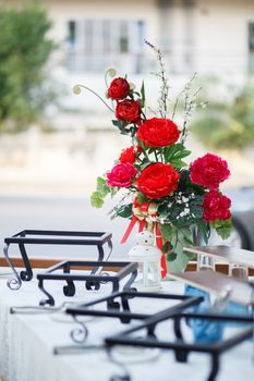 Batch of red carnation flower in glass jar