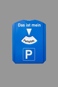 A parking disc with the german words for this is my parking lot, symbolizes parking problem