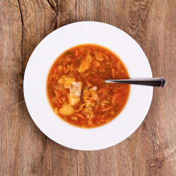 Vegetarian vegetable soup on a wooden table