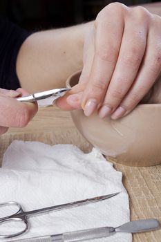 Professional manicure procedure in beauty salon. Hands close up.