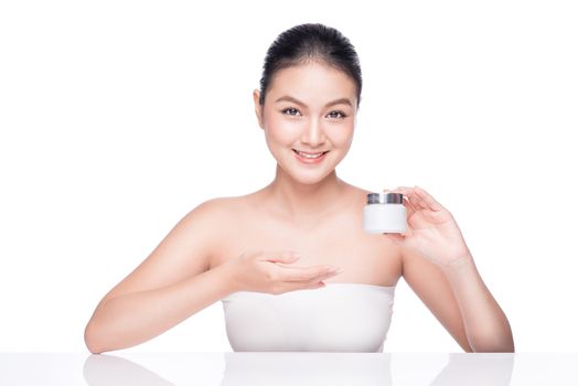 Beauty treatment. Asian woman holding moisturizing cream box.