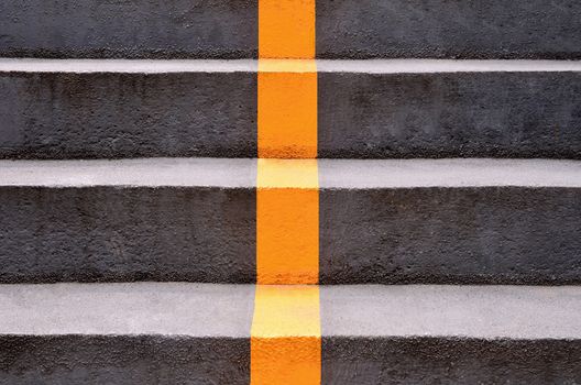 concrete stairs with yellow lines dividing the way down.