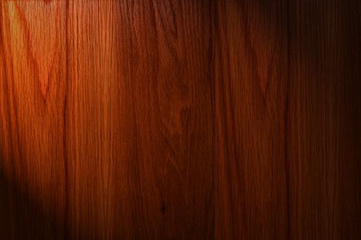 Dark brown wood background with light on the left