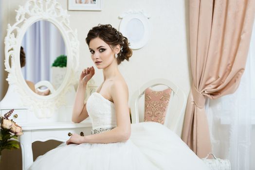 Beautiful young bride portrait with wedding makeup, hairstyle, dress. 