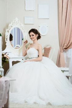 Beautiful young bride portrait with wedding makeup, hairstyle, dress. 