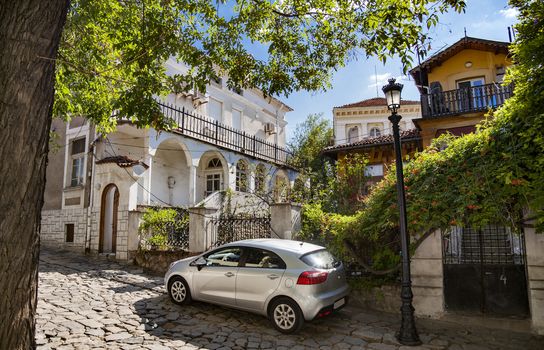 Beautiful view of several old houses in old town of Plovdiv, Bulgaria with a modern car in front.