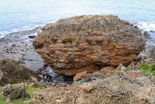 Rock and waves on the sea at rainy day in Australia.