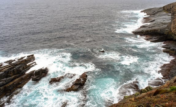 Beautiful sea with rocks and waves at the sunny day in summer