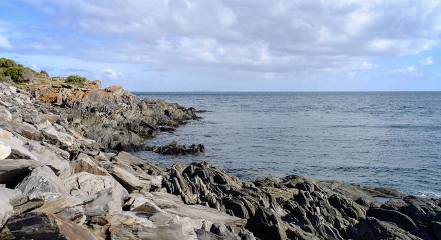 Beautiful sea with rocks under blue sky at the sunny day in summer time