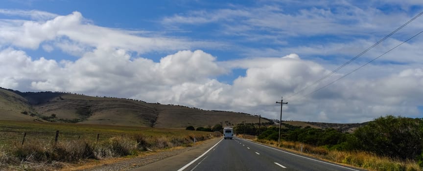 Cloudscape with mountain road at sunny day in South of Australia.