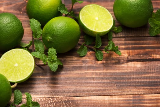 Fresh limes on wooden  table, Top view, background.