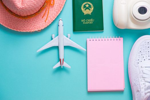 Vacation concept. Top view of travel accessories set on wooden background with copy space