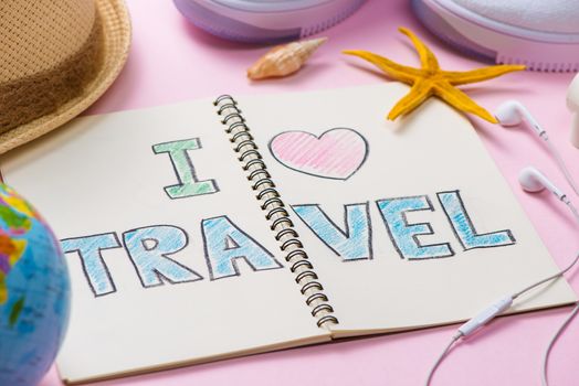 I love Travel written on pen notebook. Vacation Holiday Concept