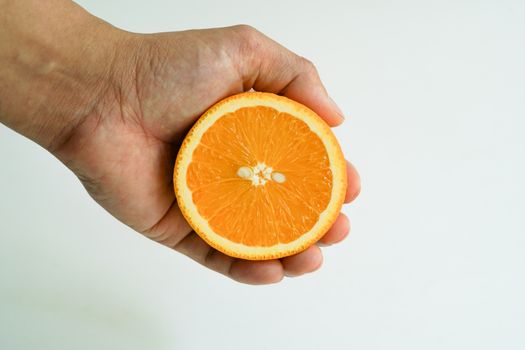 Slice organic orange holding on the hand