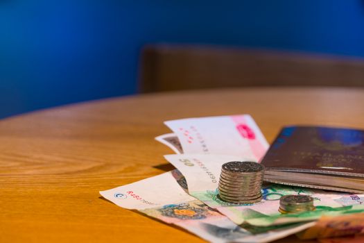 Pocket money for traveling and working. The coin, bank note and passport are ready for working aboard.