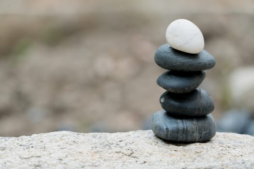 The different always outstanding and put on top,  zen stone, balance, rock, peaceful concept