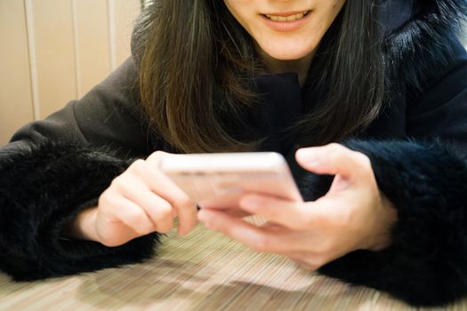 Socialholic young woman smile to her smart phone