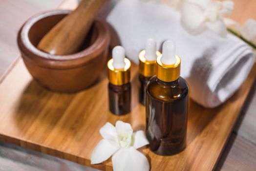 Spa still life with towel, white orchid, bath oil