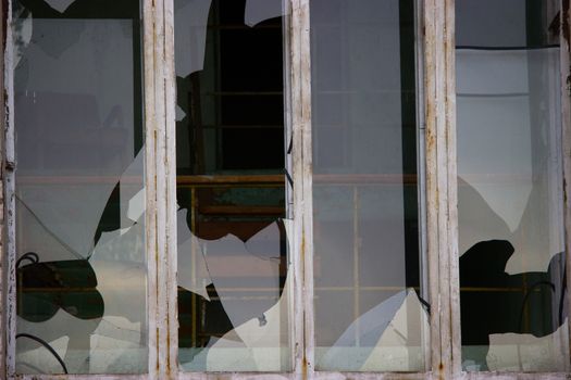 Broken windows in an old abandoned brick building