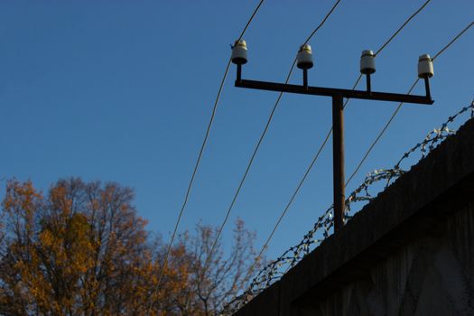 fenc ewith an electricity wire and a barbed wire