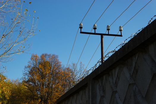 fenc ewith an electricity wire and a barbed wire