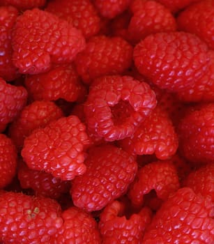 Close up of fresh red ripe raspberries background pattern, high angle view