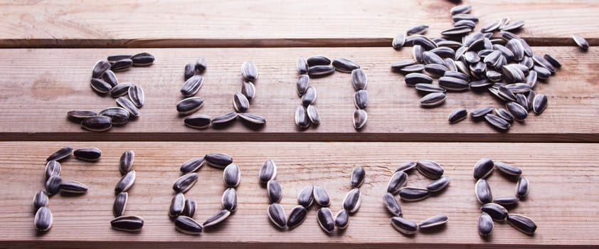 sunflower word from sunflower seeds on table. concept