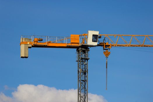 yellow construction crane on blue sky background