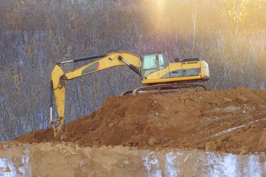 yellow excavator on the ground. construction concept