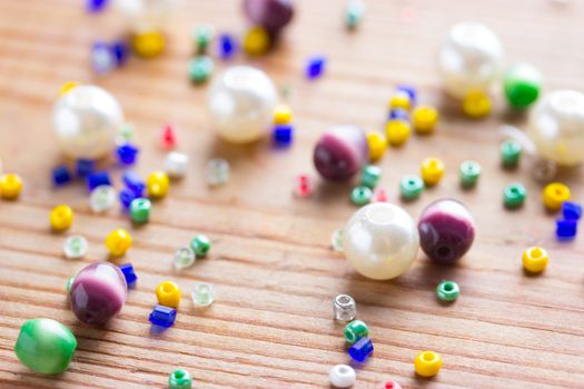 colorfuld beads on wooden table. close up