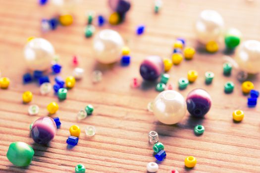 colorfuld beads on wooden table. close up