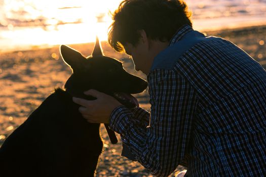 man and his dog on the beach. best friends