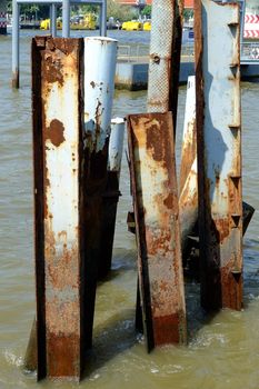 Metal posts left over from an old pier in Chao Phraya River Bangkok, Thailand.