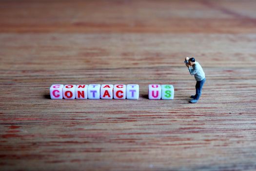 Miniature Photographer, Taking Picture of Contact Us Cubes.