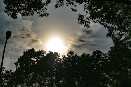 dramatic sun rays through dark sky, with filter