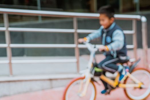 Blurred photo of asian boy riding bicycle in winter season