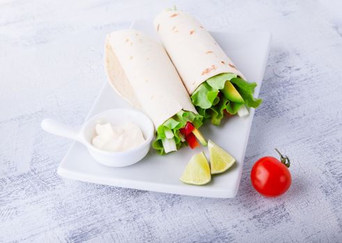 Vegetable wrap sandwiches on a white plate