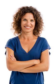 Smiling middle aged woman with arms folded, isolated on white background