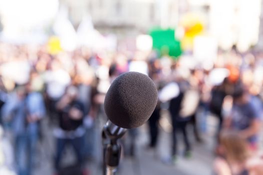 Microphone in focus, blurred crowd in background