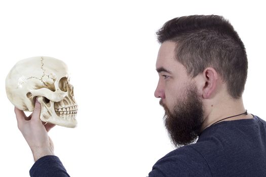 Bearded man with a human skull in his hand
