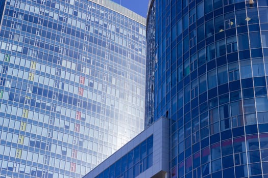 Fragment of two neighboring buildings of a large modern multistory reinforced concrete office center 
