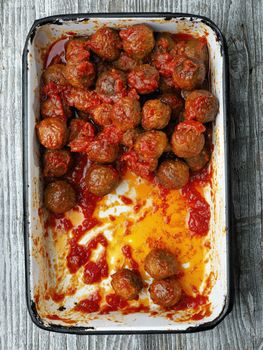 close up of rustic italian meatball in tomato sauce