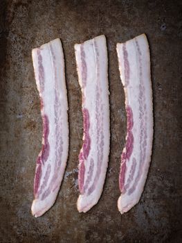 close up of rustic uncooked bacon