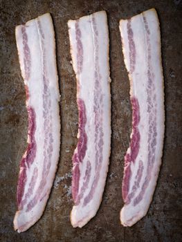 close up of rustic uncooked bacon