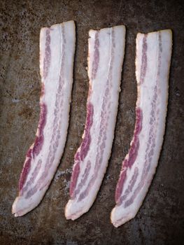 close up of rustic uncooked bacon