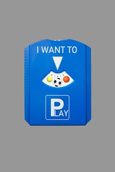 A german parking disc with the words I want to and Play and sports balls, isolated on grey