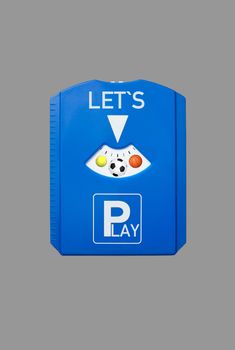 A german parking disc with the words Let´s and Play and sports balls, isolated on grey