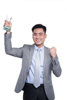 Successful asian businessman holding a trophy on white background