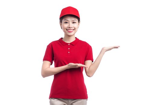 Portrait of delivery woman show something isolated on white background.