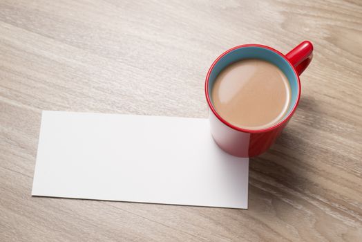 Blank paper and cup of coffee on the desk